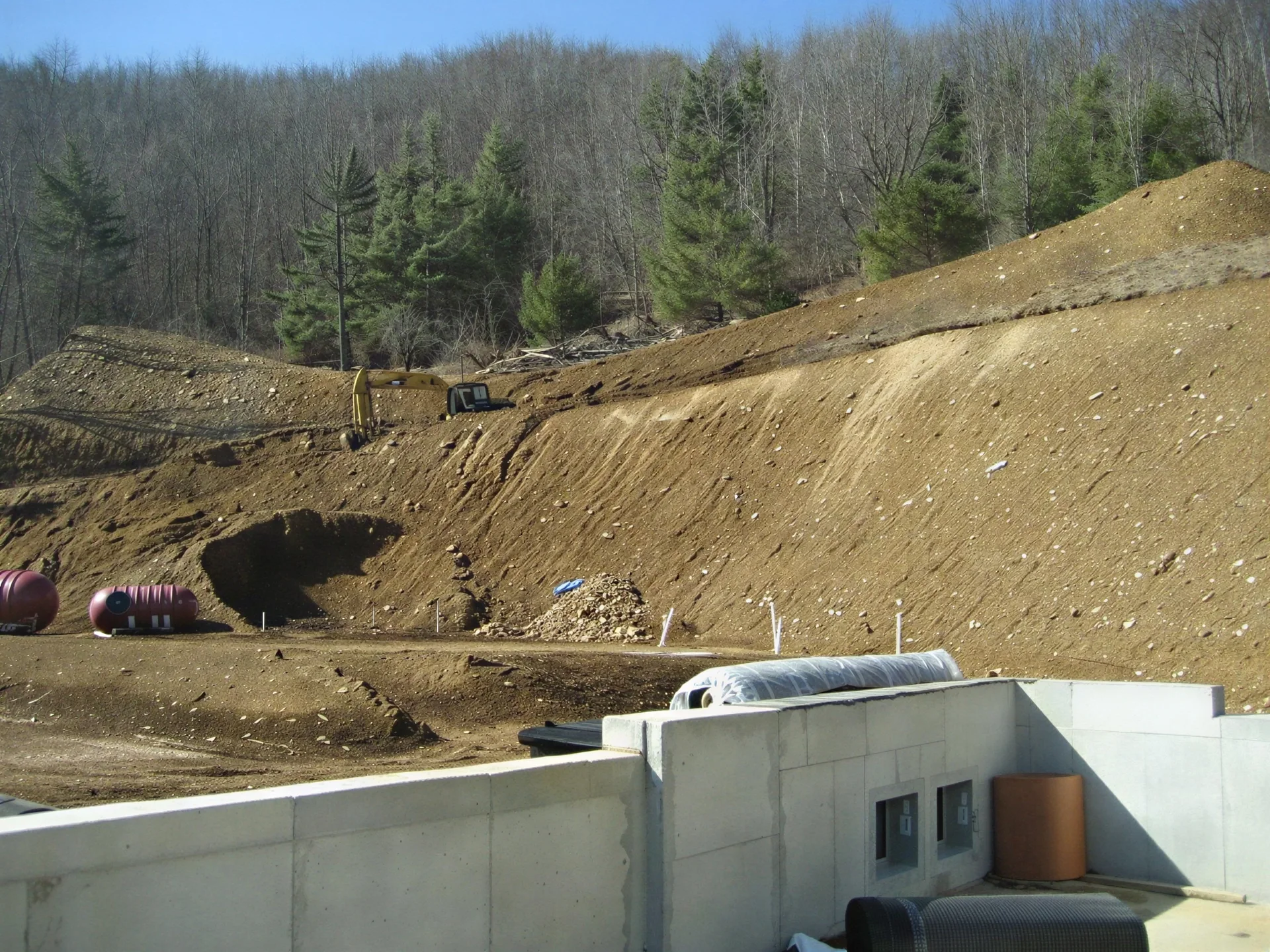 Heavy equipment excavating a large building site into a hillside